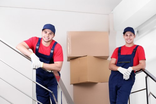 Local movers loading a van on a residential street
