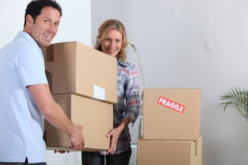 Movers handling office equipment during a commercial relocation